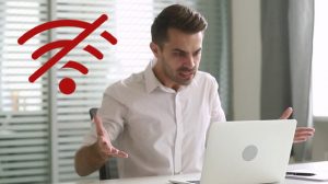 Guy Looking at Laptop Angry with Hands Up, WiFi Connection Icon with Strike Through