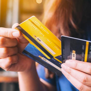 woman holding multiple debit cards