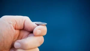 Hand about to toss a coin