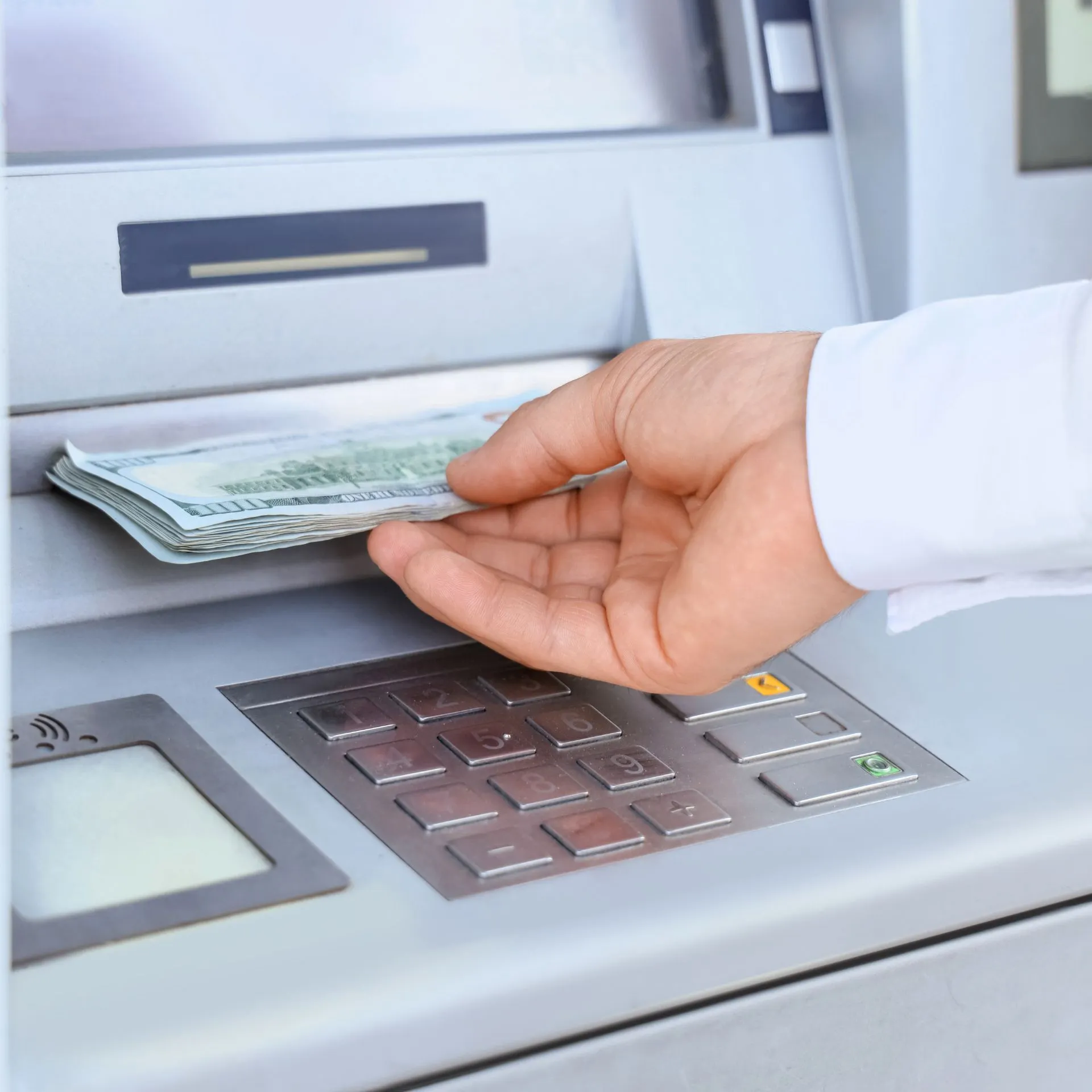 someone withdrawing cash from atm