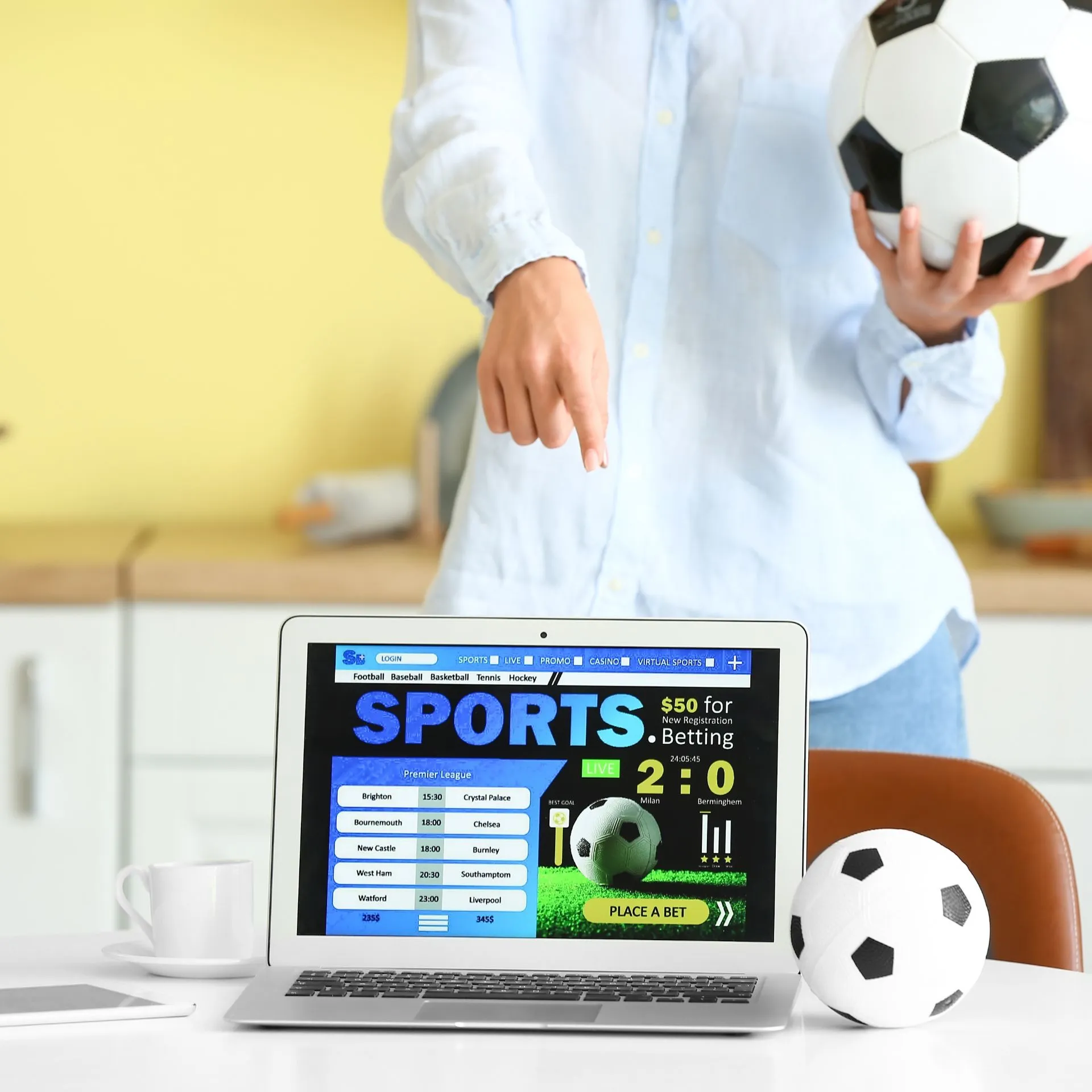 someone pointing to laptop with sportsbetting on it