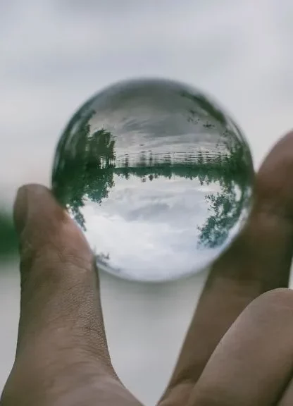 hand holding transparent orb