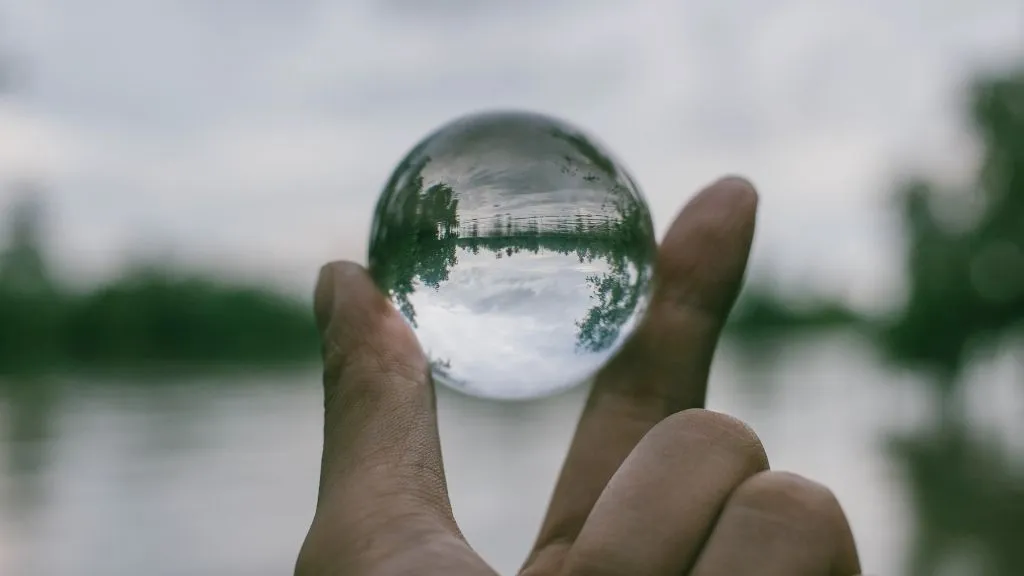 hand holding transparent orb