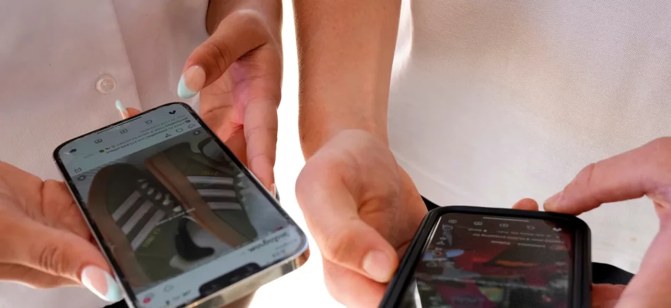 Two people using cell phones