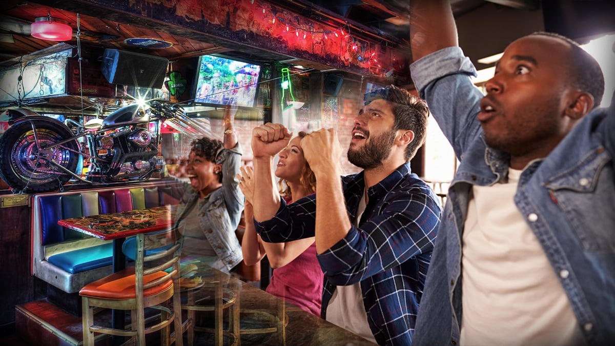 Backgrounf of a Bar full of people watching sports