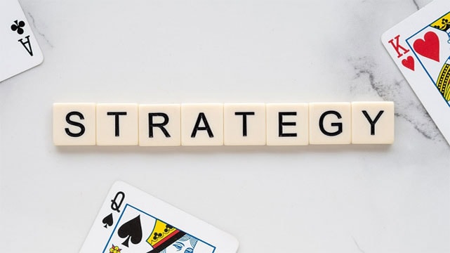 The Word Strategy Surrounded by Playing Cards