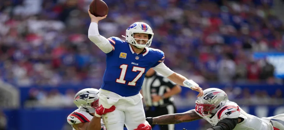Bills QB Josh Allen throwing a ball under pressure